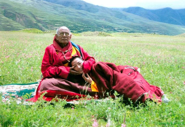 His Holiness Gyalwai Nyugu Rinpoche resting his head on his teacher HH Lama Achuk Rinpoche's lap
